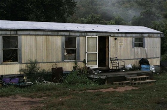 The door remains open after neighbors say Stanley Neace kicked it in and killed four people in the trailer in a shooting rampage that left a total of five people and Neace dead in Jackson, Ky., on Sept. 11.